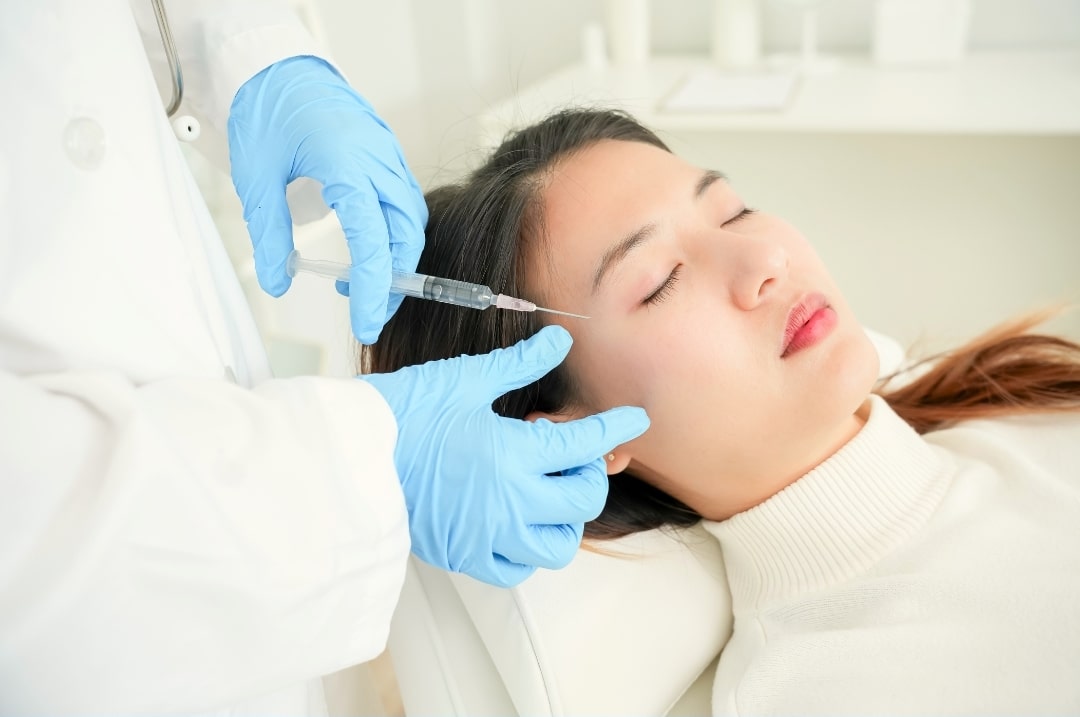 woman getting rejuran injection on her face