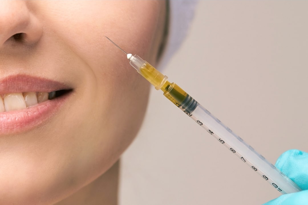 doctor injecting rejuran into patient's cheek