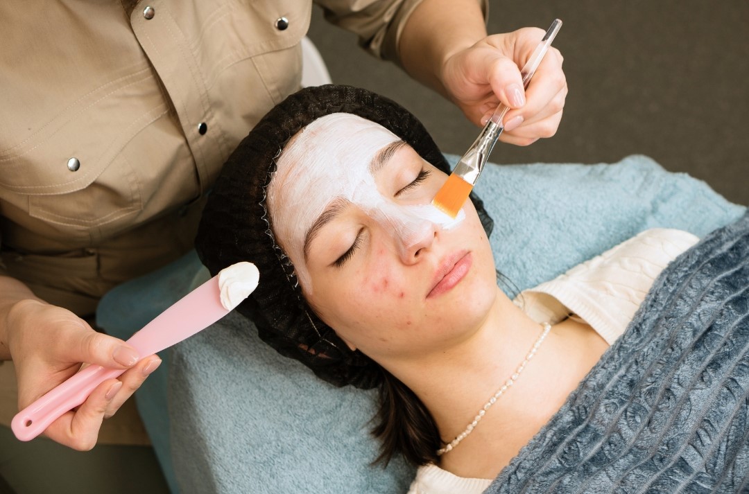 woman receiving acne treatment