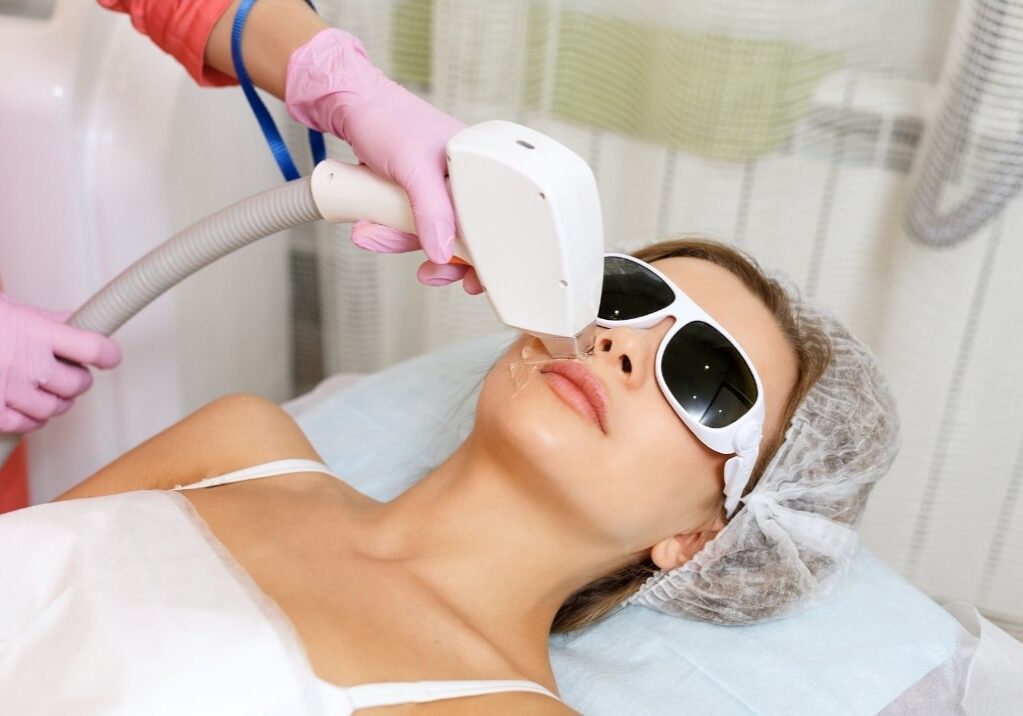 woman receiving laser treatment on face