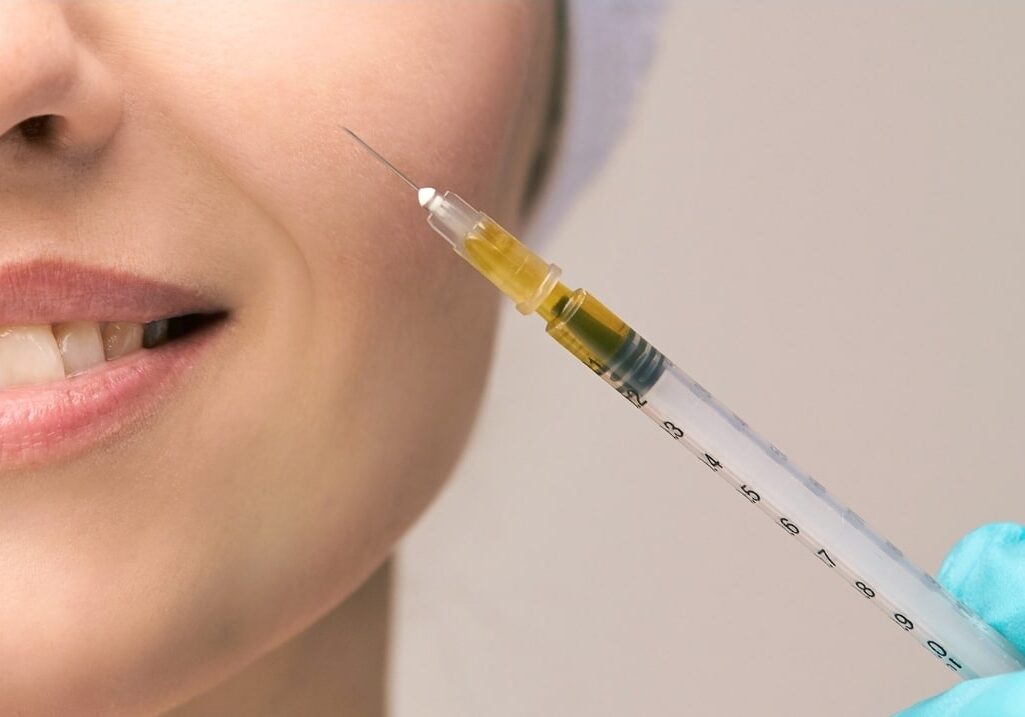 doctor injecting rejuran into patient's cheek